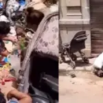 Captan a mujer cubana con dos niños chiquitos recogiendo cosas de la basura en La Habana